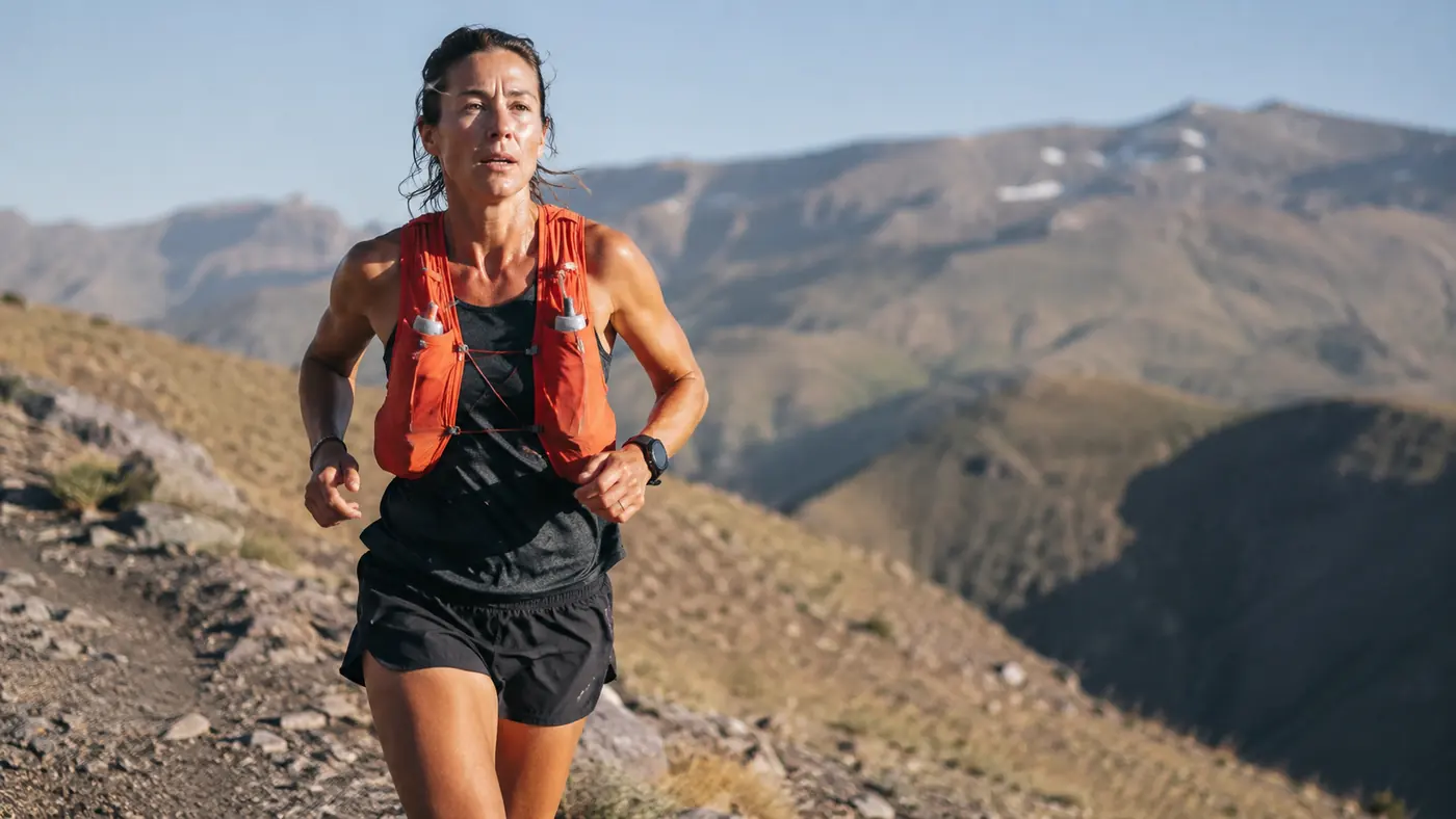 A runner mid-stride on a dry, high-altitude Colorado trail during a long Sunday run